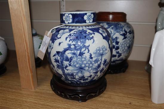 Two Chinese blue and white jars and covers and a pair of hardwood stands